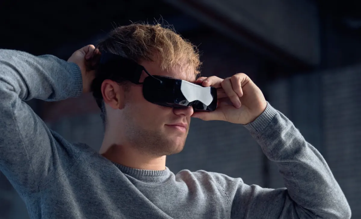 A person putting on Bigscreen Beyond