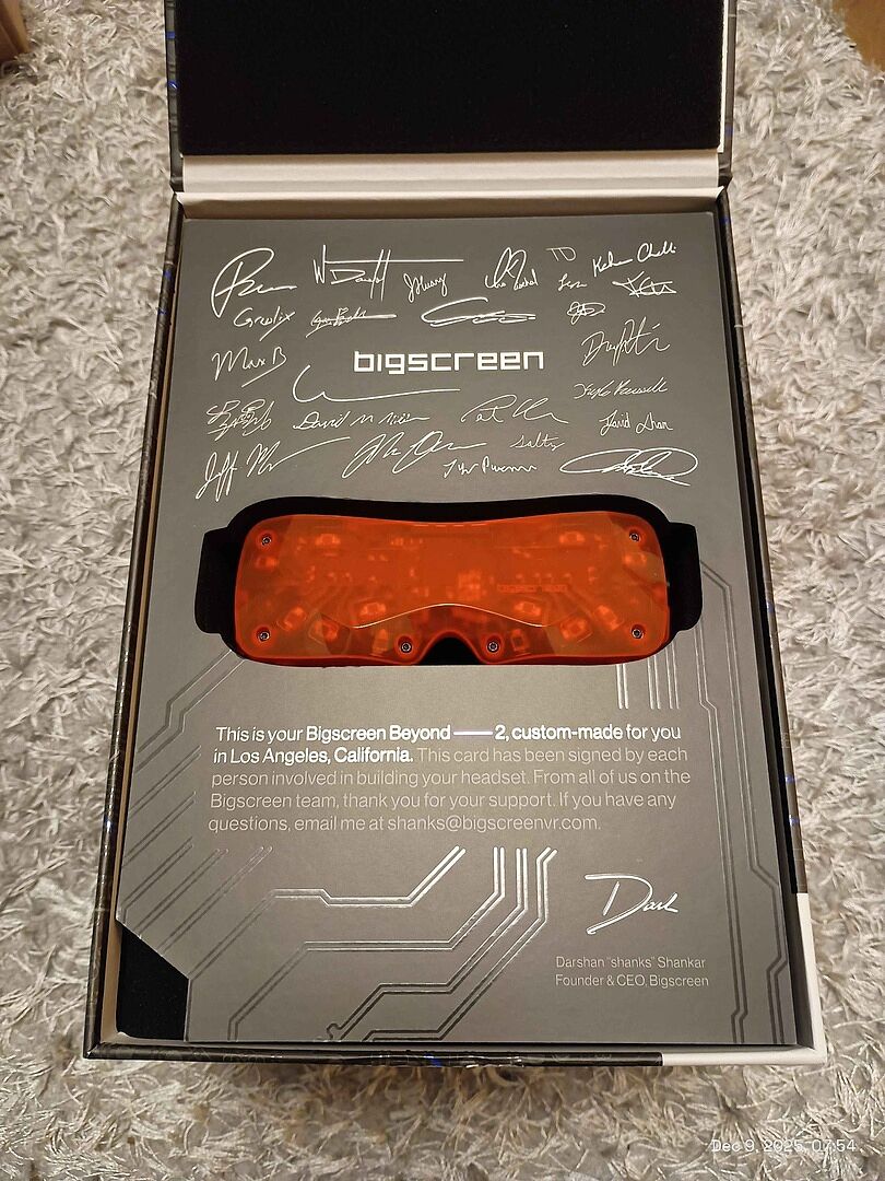 Customer photo: an orange Beyond 2 in its box, under the card signed by the team that built it